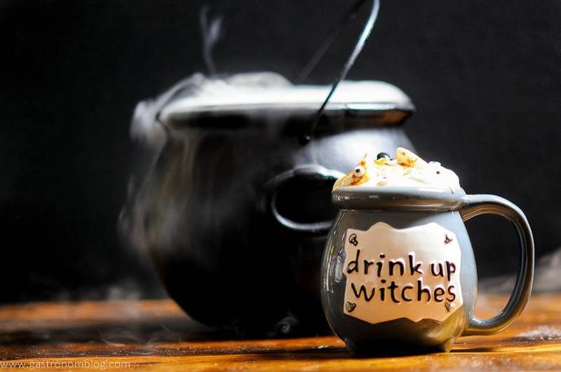 Halloween Cocktail in a cauldron with whipped cream