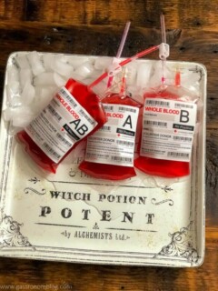Red cocktails in iv bags on white platter