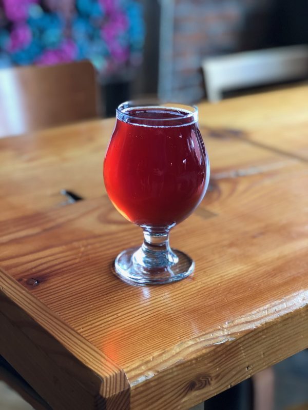 Apple Hard Cider, red in glass on wood table