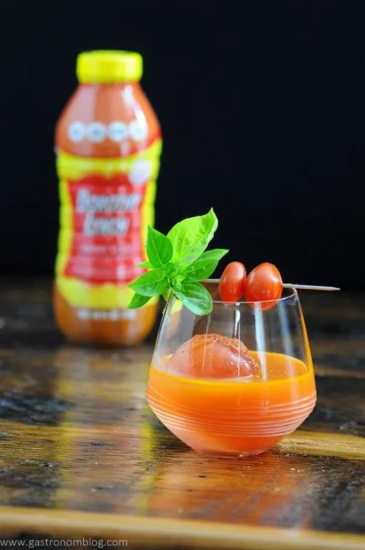 Orange cocktail with tomatoes and basil, Dorothy Lynch bottle in background