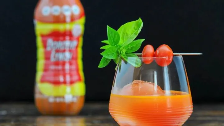 Cocktail in glass, tomatoes and basil. Dorothy Lynch bottle in background