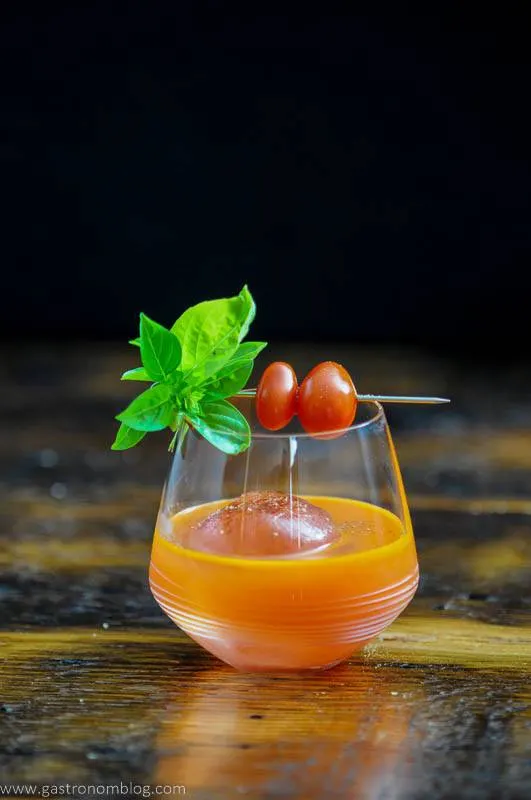 Orange cocktail with tomatoes and basil