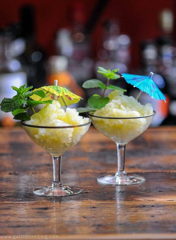Yellow cocktails in coupes with umbrellas