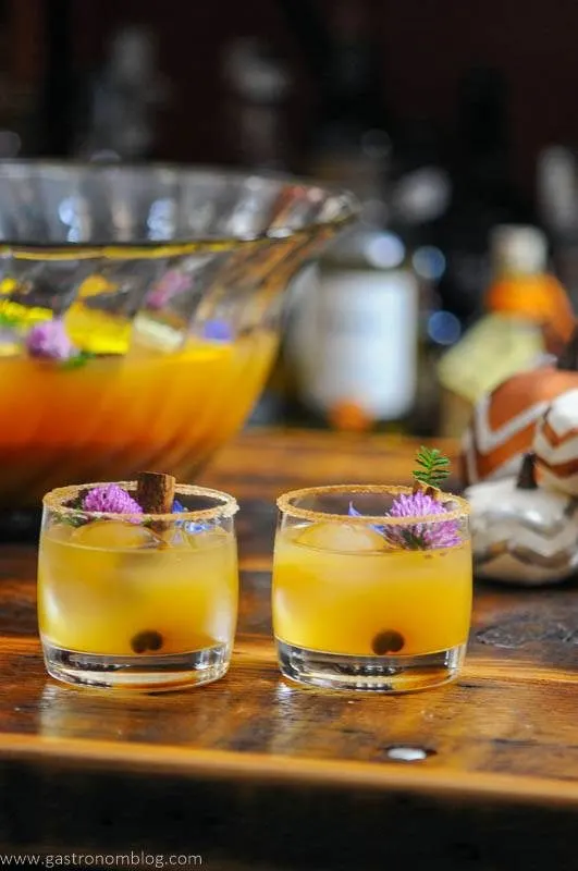 Punch cups with pumpkin punch, punch bowl in background