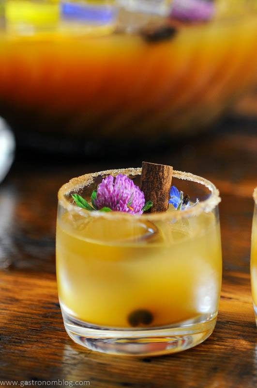 Punch cup with edible flowers and cinnamons stick