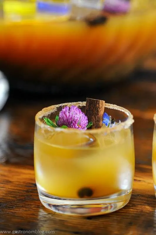 Punch cup with edible flowers and cinnamons stick
