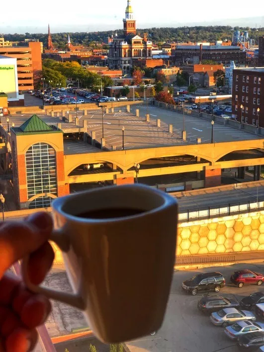 View of downtown Dubuque Iowa, hand holding coffee cup