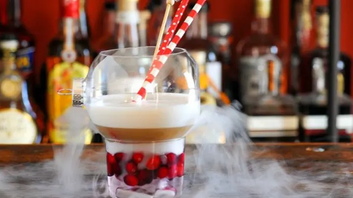 Cocktail in ornament glass as a Christmas drink, dry ice