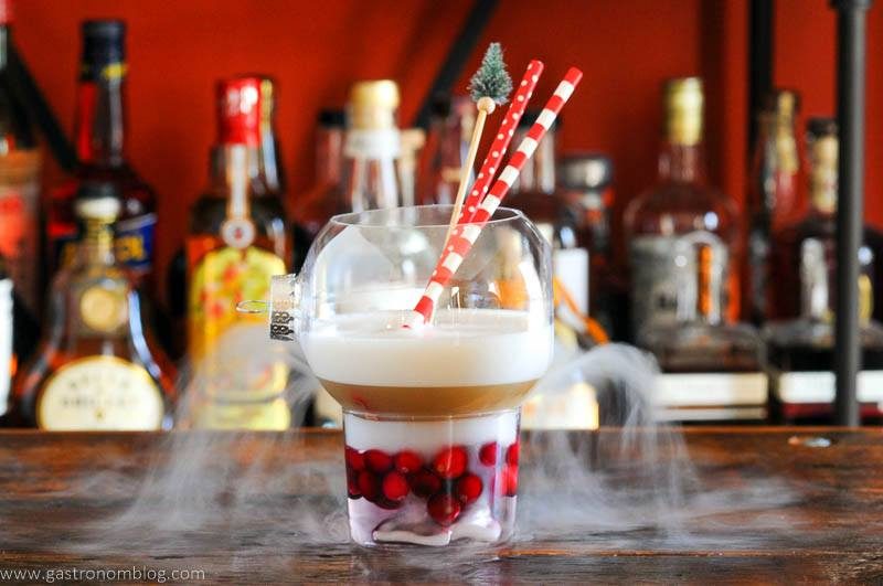 Christmas drink in ornament glass, dry ice smog, red and white straws