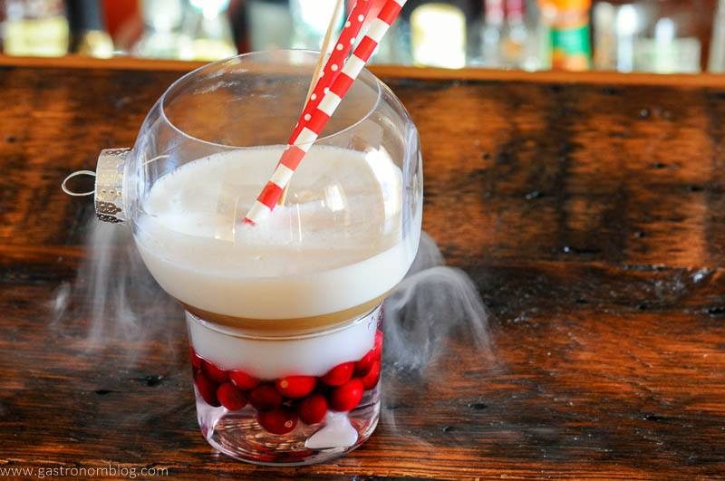 Cocktail in ornament glass with red and white straws