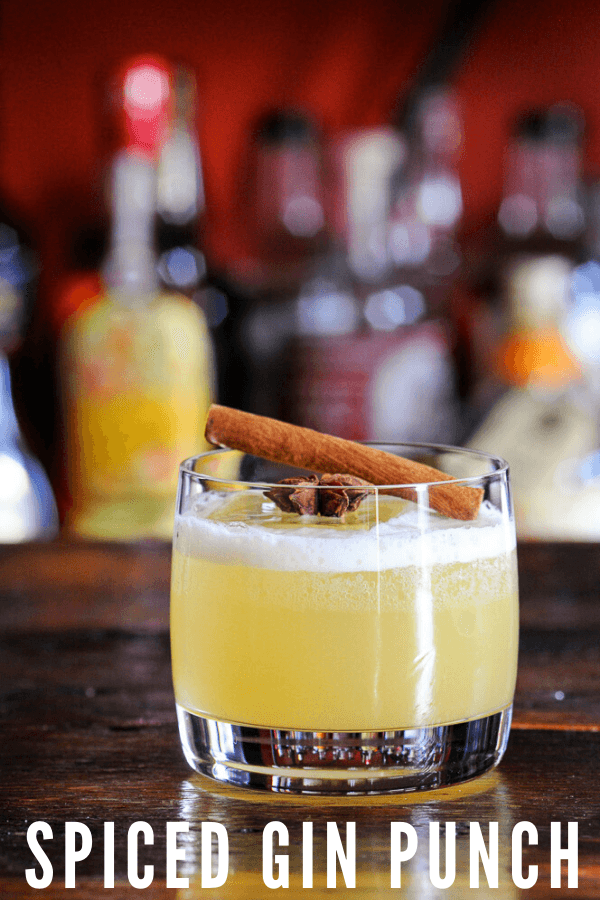 yellow Spiced Gin Punch in rocks glass with cinnamon stick
