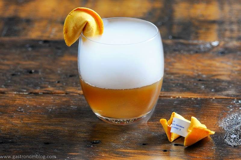 Tan cocktail with dry ice and fortune cookie