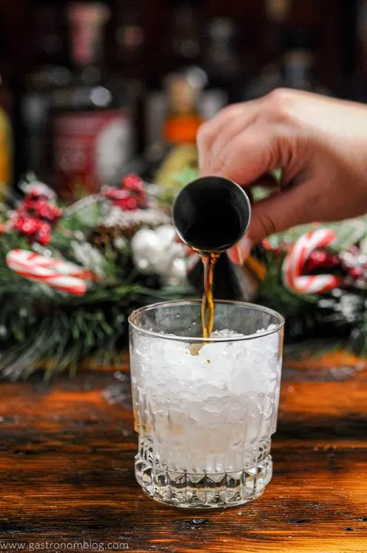 Kahlua being poured into glass with ice