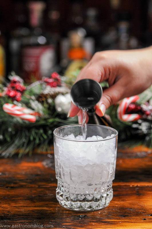 Vodka being poured into ice filled glass
