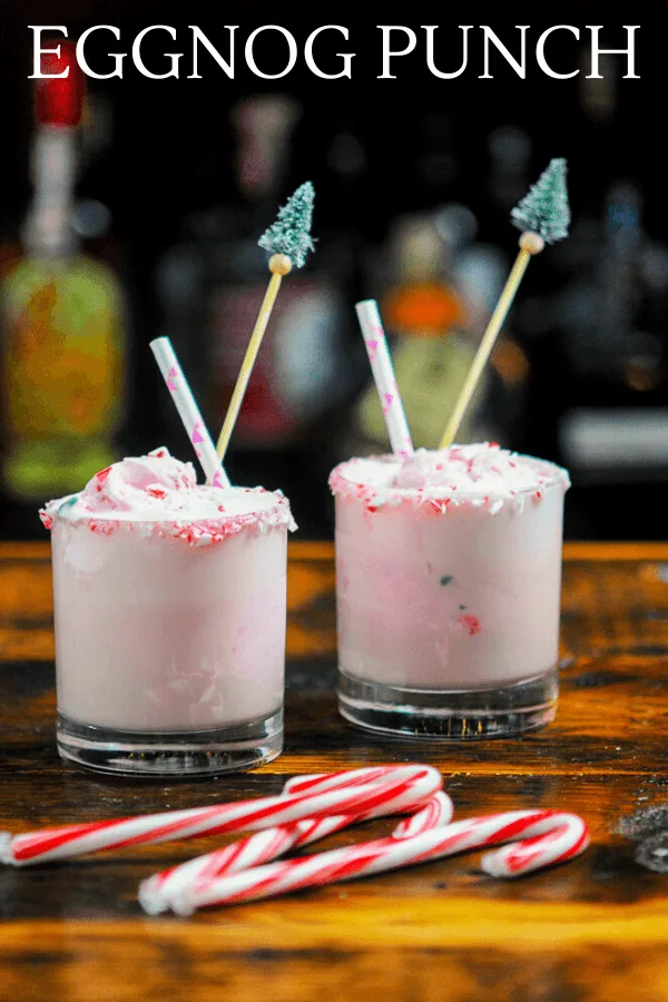 Pink ice cream Punch in glasses with candy canes and straws
