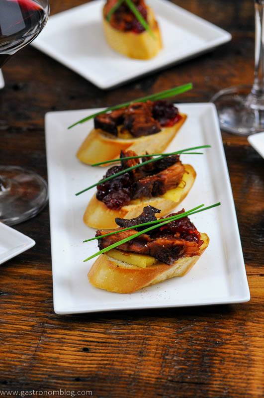 Crostini appetizers on white plates