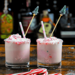 Pink Ice Cream Punch in glasses, candy canes