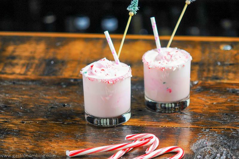 Pink eggnog punch in glasses, candy canes