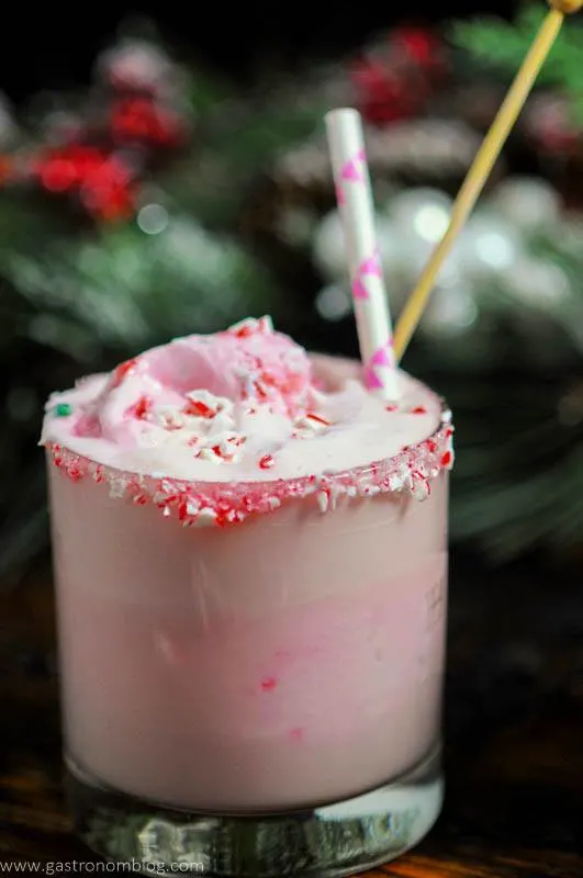 Pink eggnog punch in glass with straw