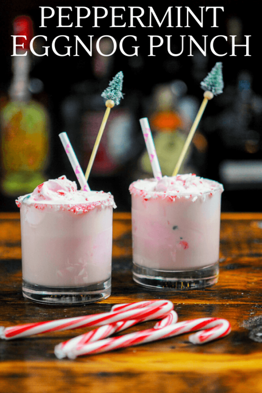 Pink cocktails in glasses with straws and candy canes