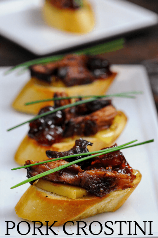 Pork Crostini with chives, on a white plate