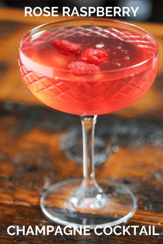 Pink cocktail in coupe, raspberries floating
