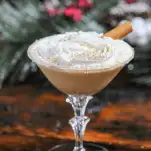 Tan cocktail in coupe with whipped cream