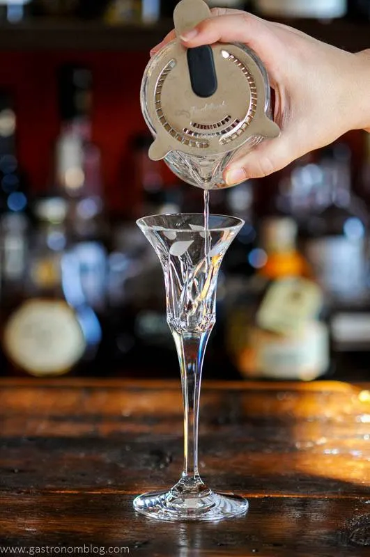 Cocktail being poured into glass