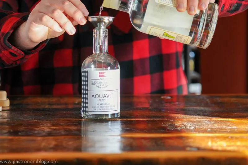 Vodka poured into aquavit cocktail bottle