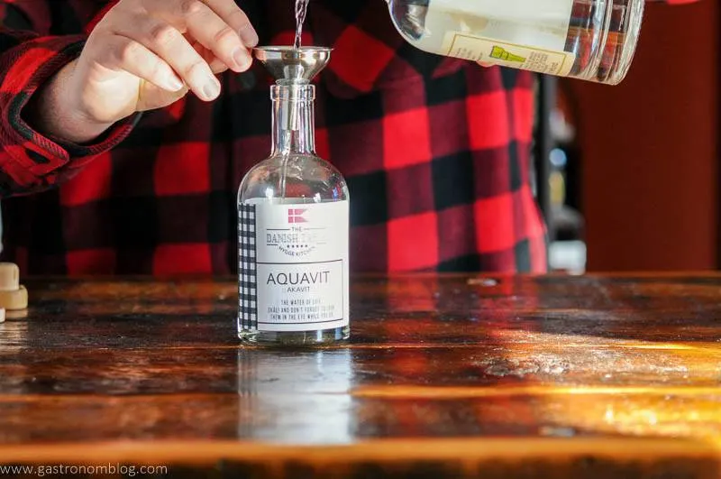 Vodka being poured into DIY aquavit kit