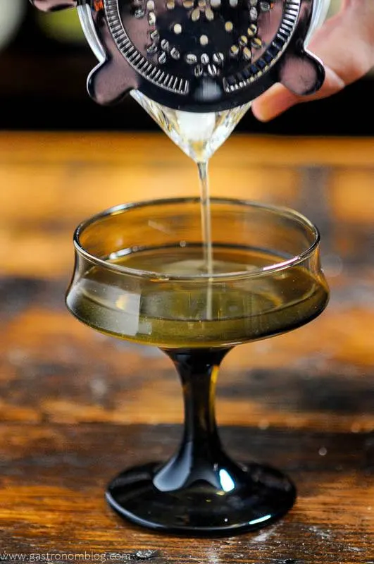 Brown glass cocktail, whiskey being poured into