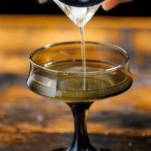 Peanut butter cocktail being poured into brown glass