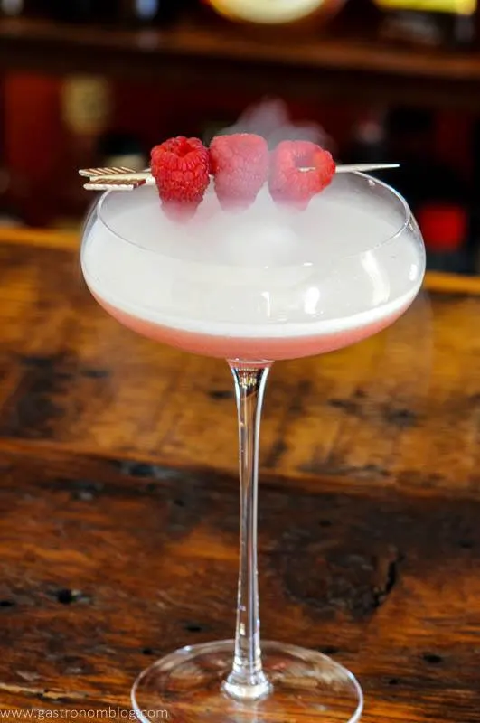 Pink Valentine cocktail with berries and dry ice