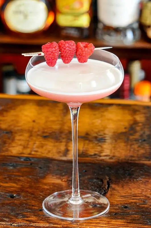 Pink cocktail in coupe with berries