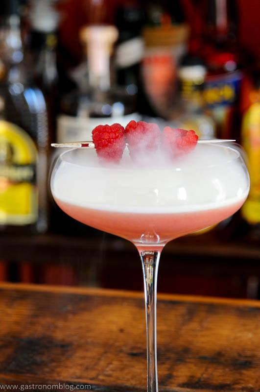 pink Valentine cocktail in coupe, raspberries and dry ice fog