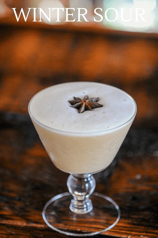 tan Cocktail with star anise on top of foam