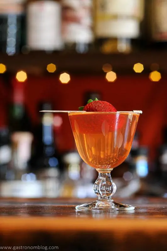 Strawberry cocktail with berry on pick