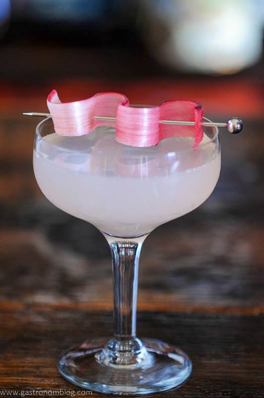 Pink Rhubarb Gimlet cocktail in coupe with rhubarb gimlet
