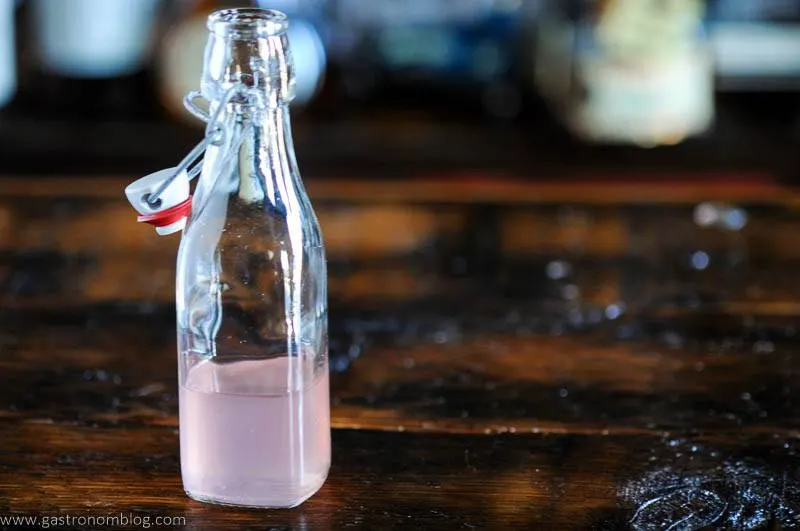 Pink syrup in a glass bottle