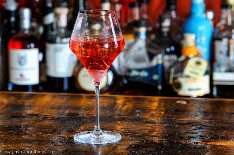 Pink cocktail in wine glass