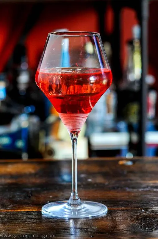 Pink cocktail in wine glass
