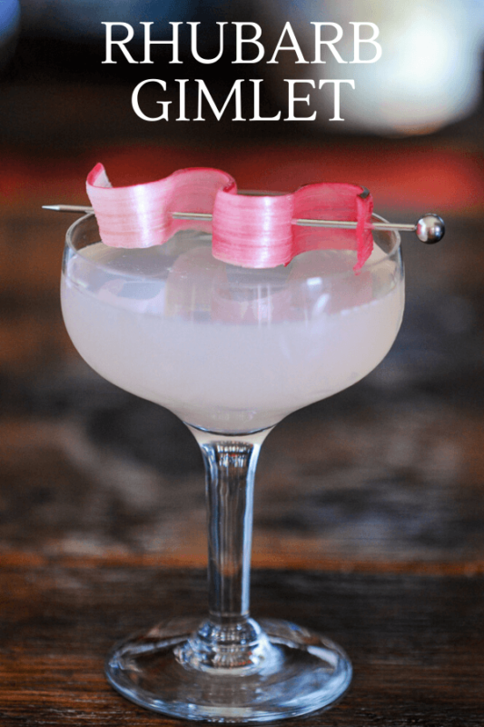 Pink cocktail in coupe with rhubarb garnish