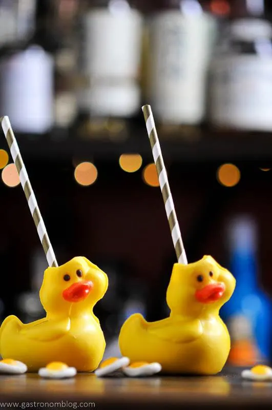 Cocktail in chocolate duck vessels with straws