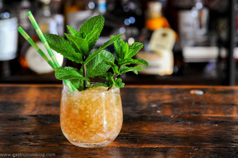 Tan Navy Grog cocktail in glass with crushed ice and mint bunches