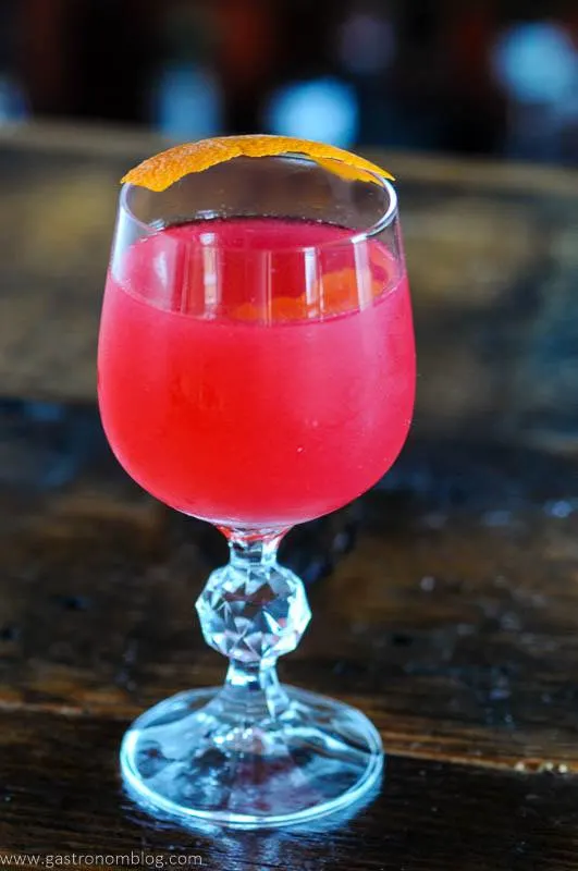 Pink cocktail with orange peel