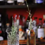 Syrup in swingtop bottle, lavender sprigs in mixing glass