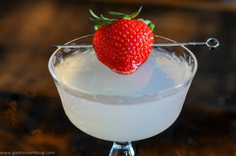 Strawberry Basil gin cocktail in coupe, strawberry on pick