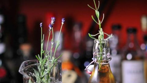 Syrup in bottle, lavender sprigs in bottle and glass