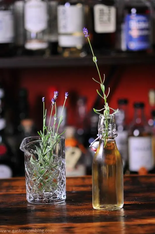 Syrup in bottle, lavender sprigs in bottle and glass