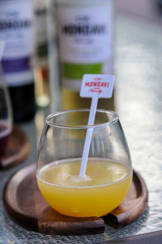 Orange cocktail recipe in wine glass with white stirrer